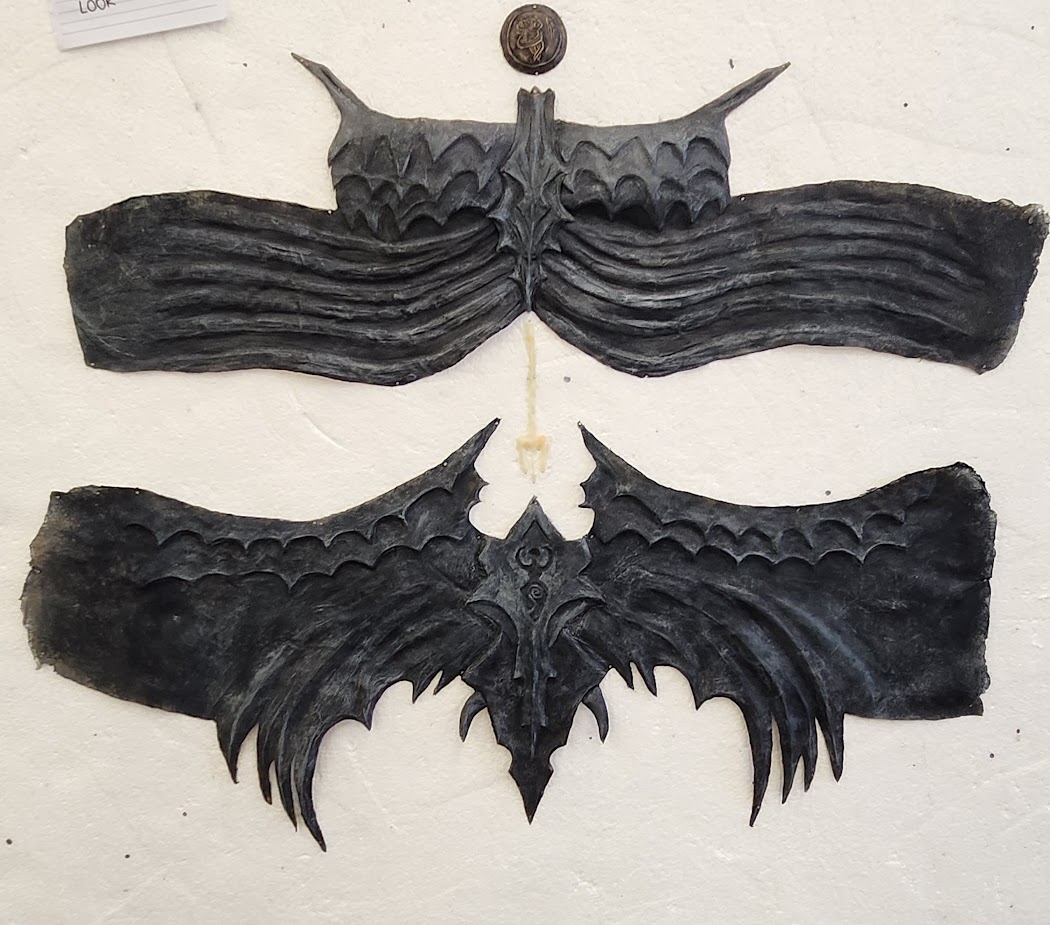 The whole costume prosthetics. Top  and bottom parts include 6 separate parts altogether. Above the top part a medallion with a defeated owl is seen and a Poseidon spear scar is between top and bottom parts.