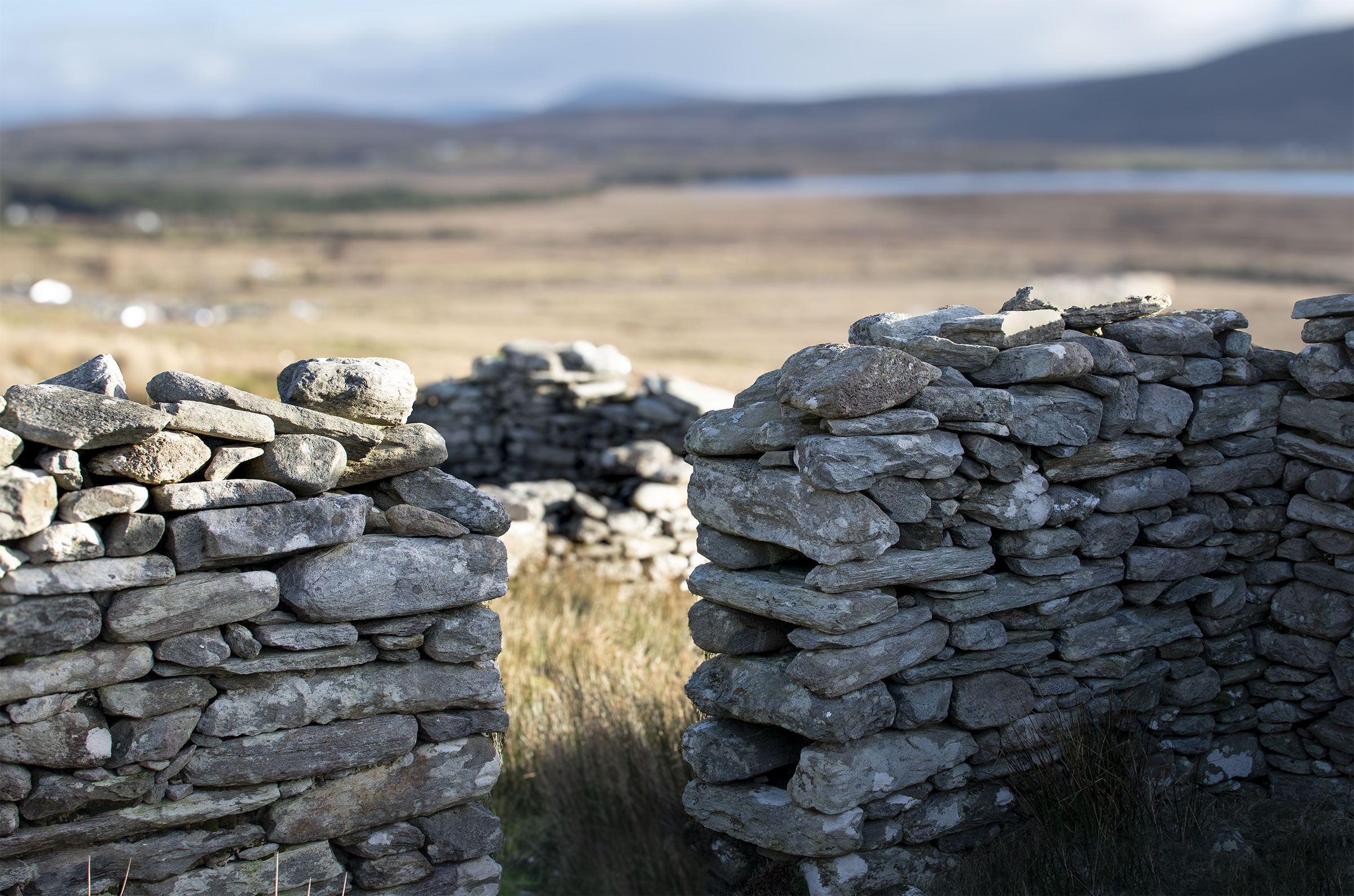 An image taken inside a stone cottage with a detailed view of the build of the old stone doorway