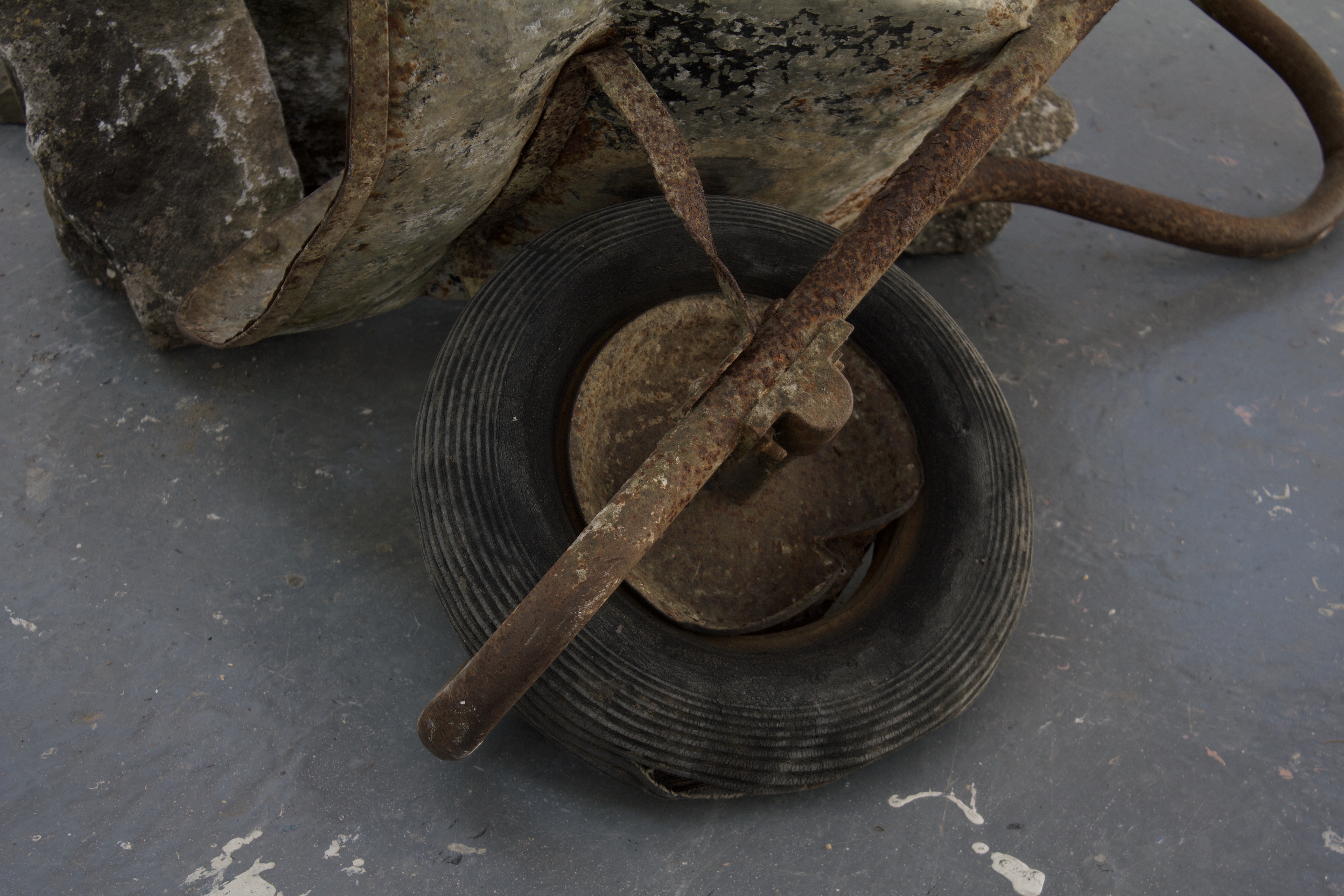 close up of rusty wheelbarrow tyre, rim is bent