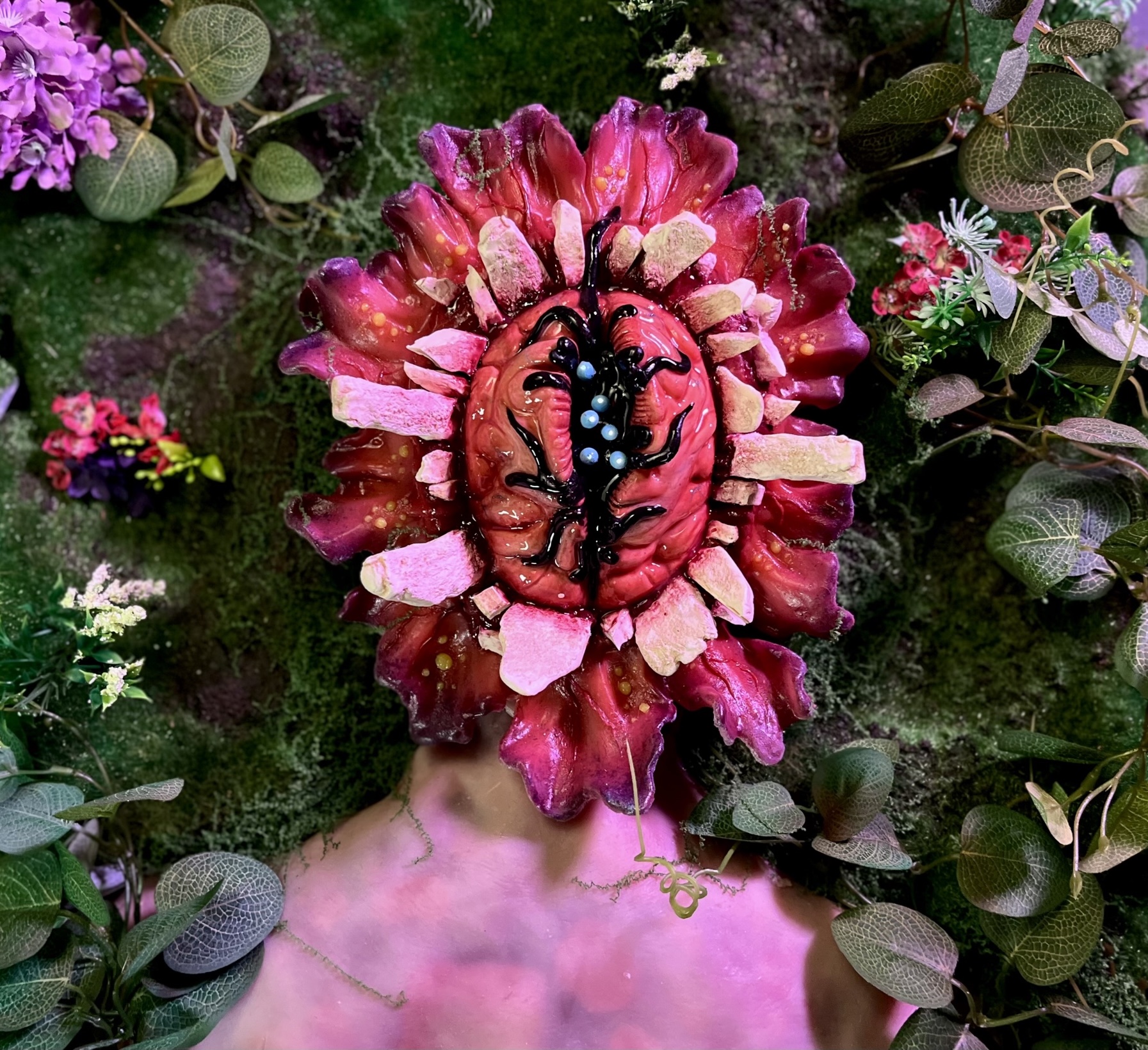 front view of skull ripper lying down in a flower bed 