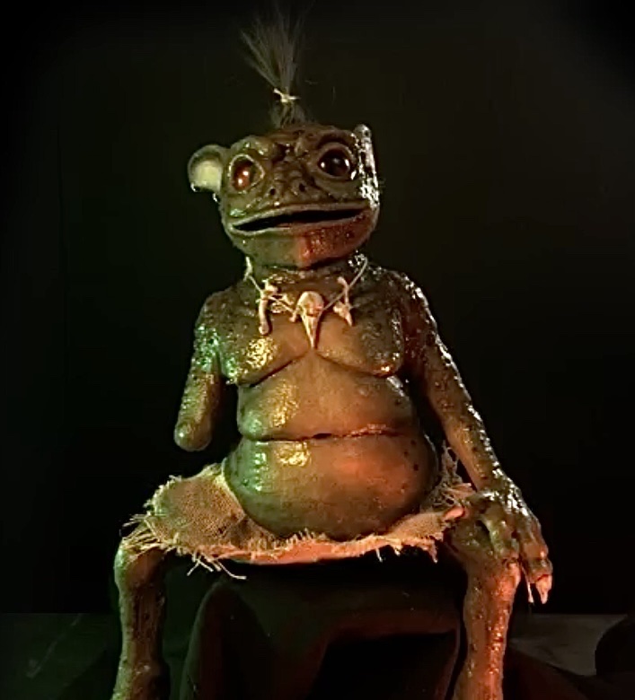 Front view showing accessories such as a necklace with a thrush skull, a bone and a tooth. He wears a garment made from hessian fabric as he is semi-sentient. also visible is his hair made from guinea pig hair which was hair punched into the silicone.