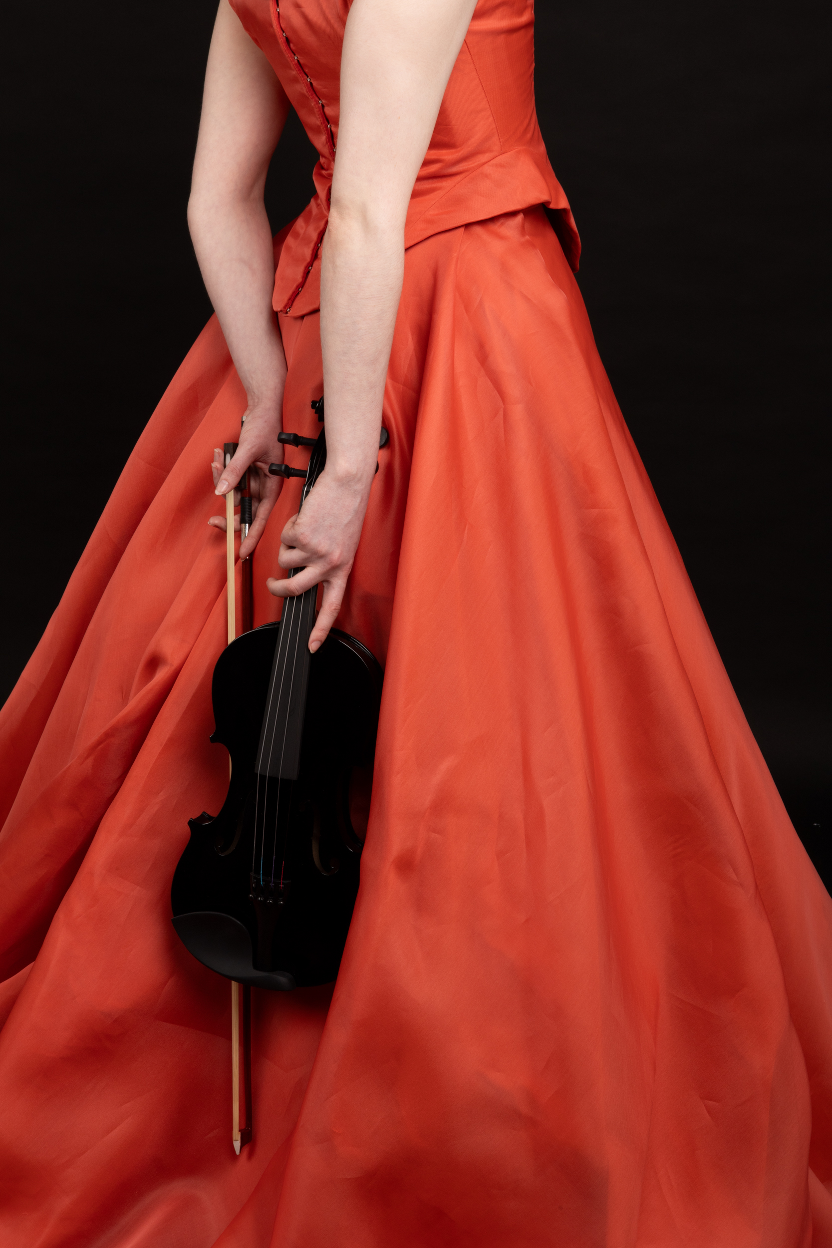 Girl in red dress holding violin