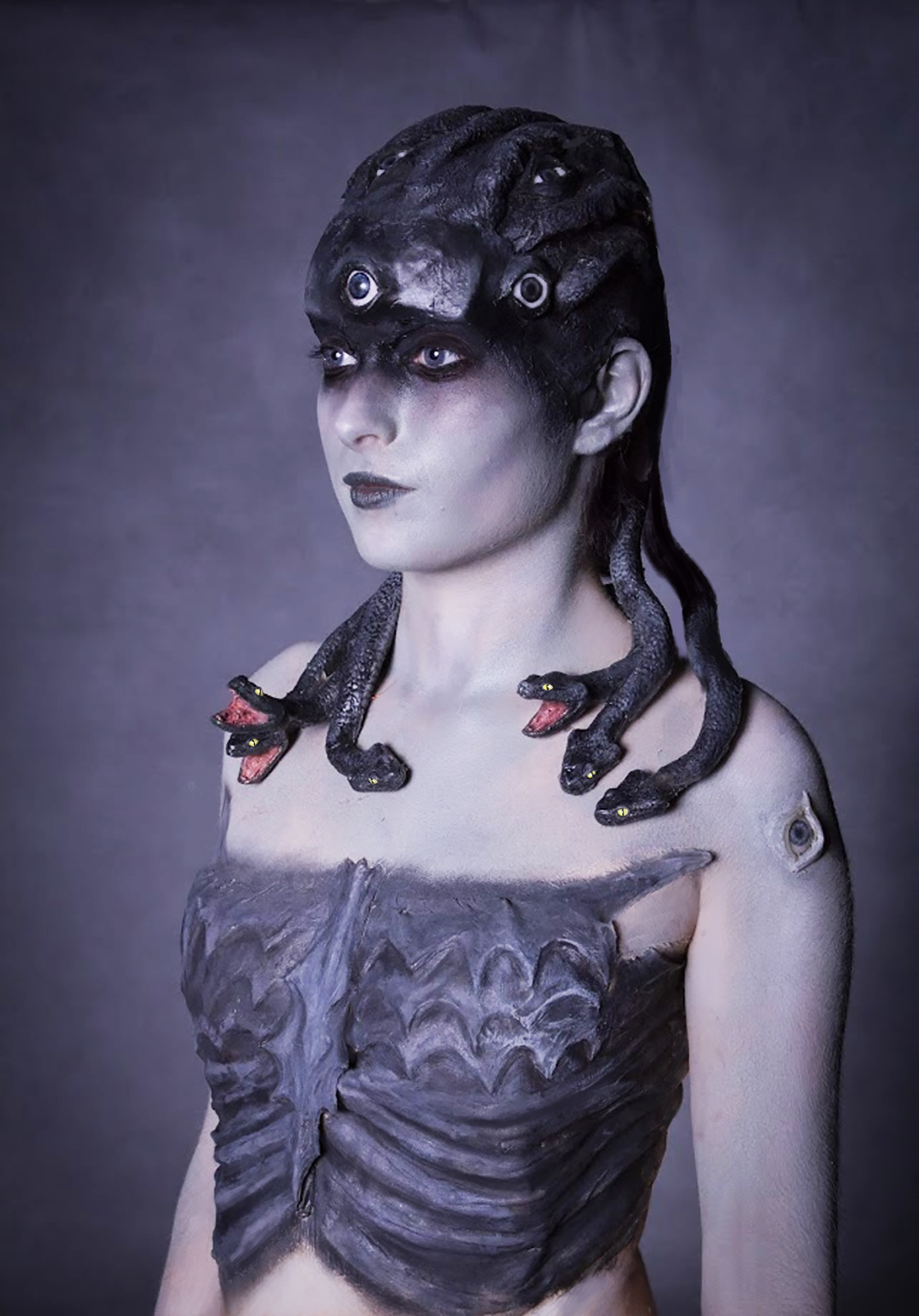 Medusa side shot. Head piece is made out of several parts like bald cap head base, eyes with eyelids, snake skins and snake bodies with two different heads styles.