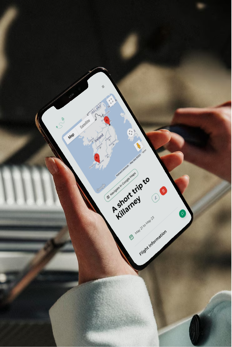 Woman with a suitcase holding a phone with her itinerary open 