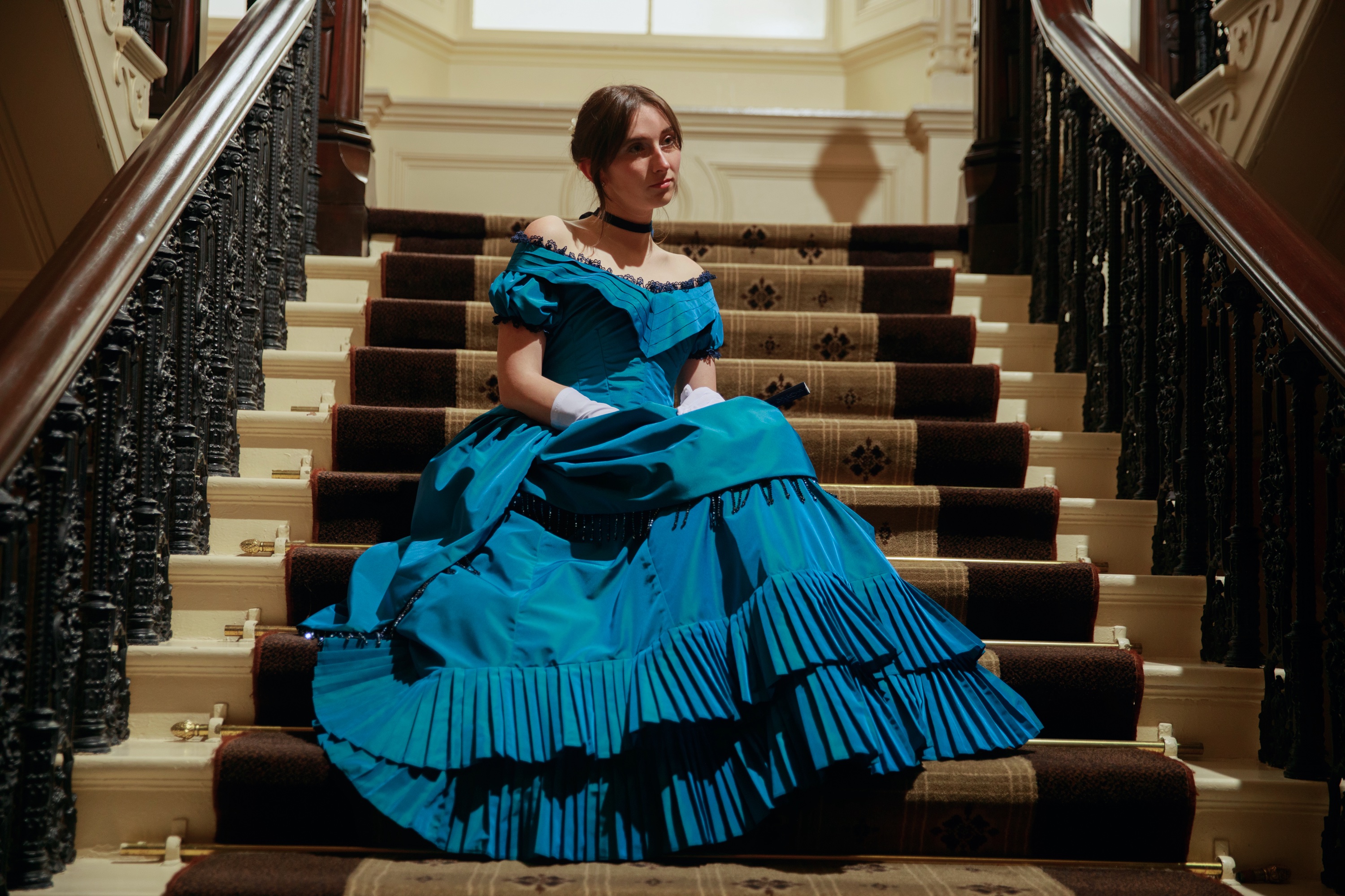 Landscape shot of model sitting on stairs