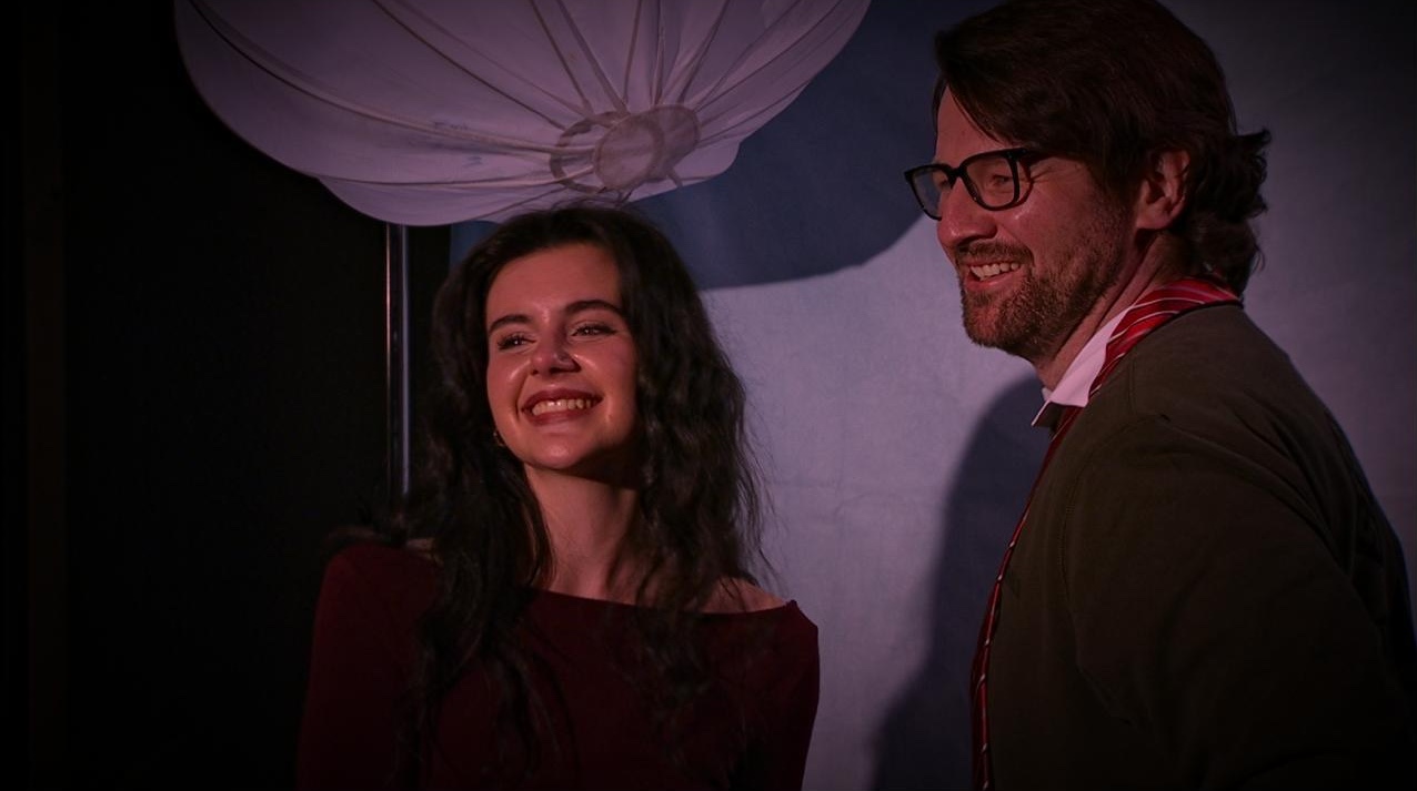 Franke shaking Victor Trumans hand while smiling into the spotlight