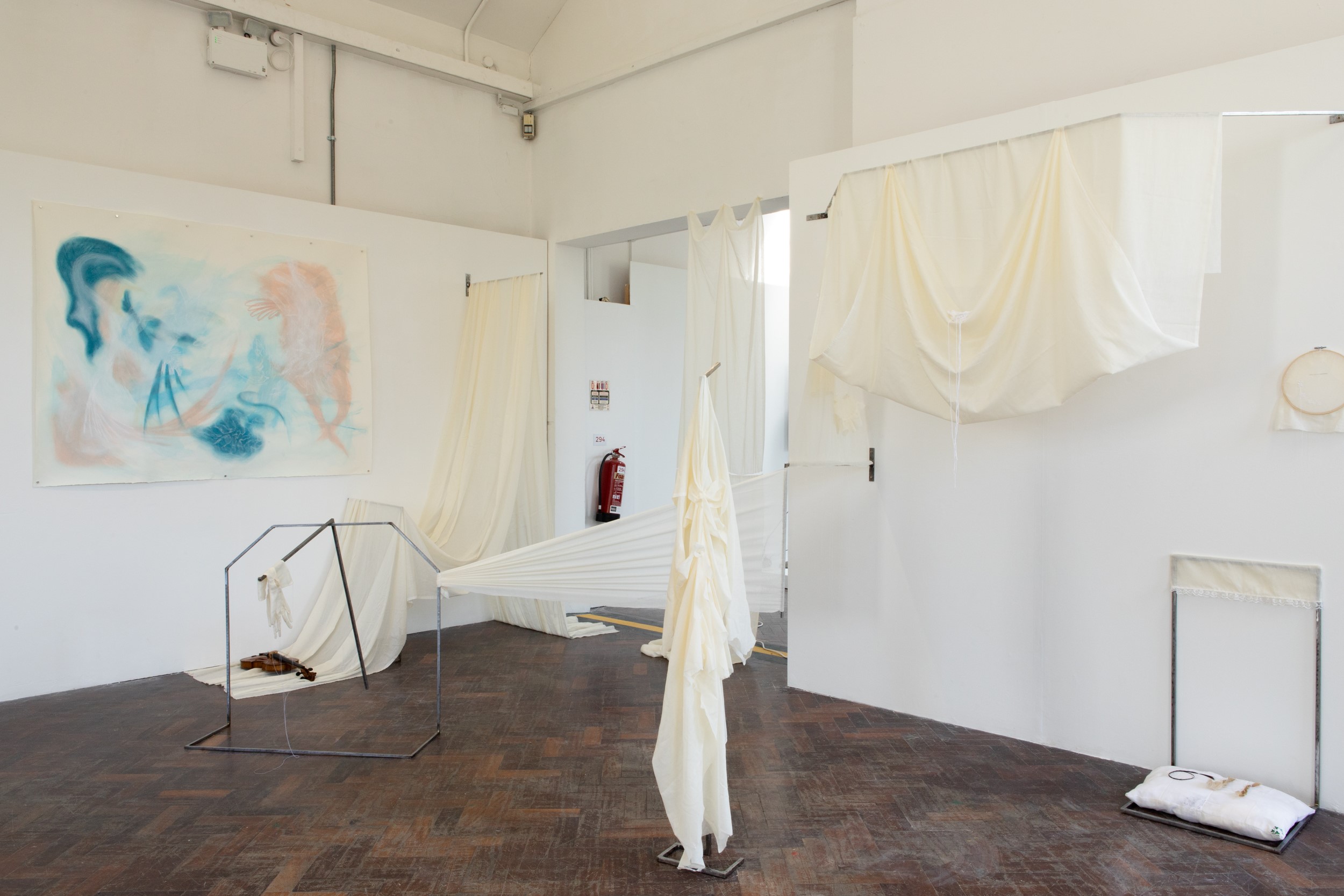 Síofra Ní Bhroin, **Truth to tell, just being here, Housed alone, housed together,**, 2025. Cotton muslin, Violin, Yarn, Thread, Hawthorn dye, Mild steel.