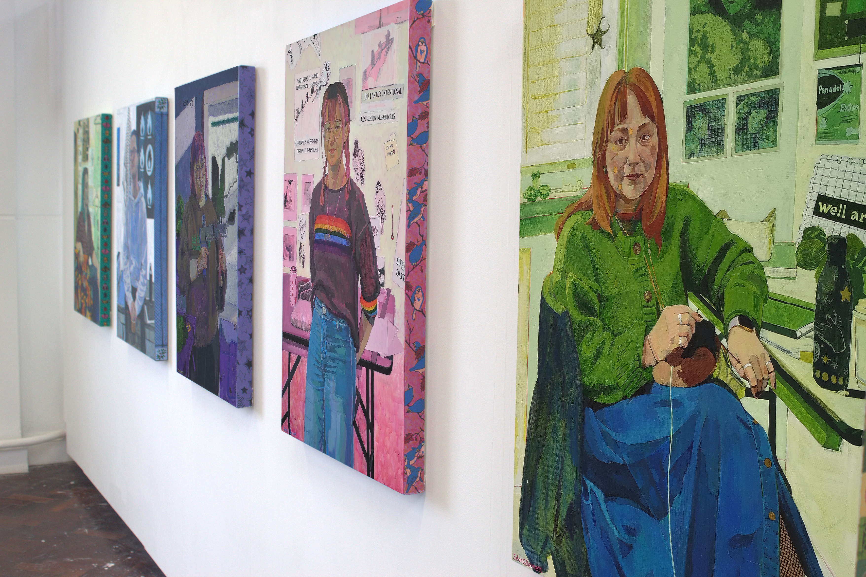Five portrait hung on a wall.
