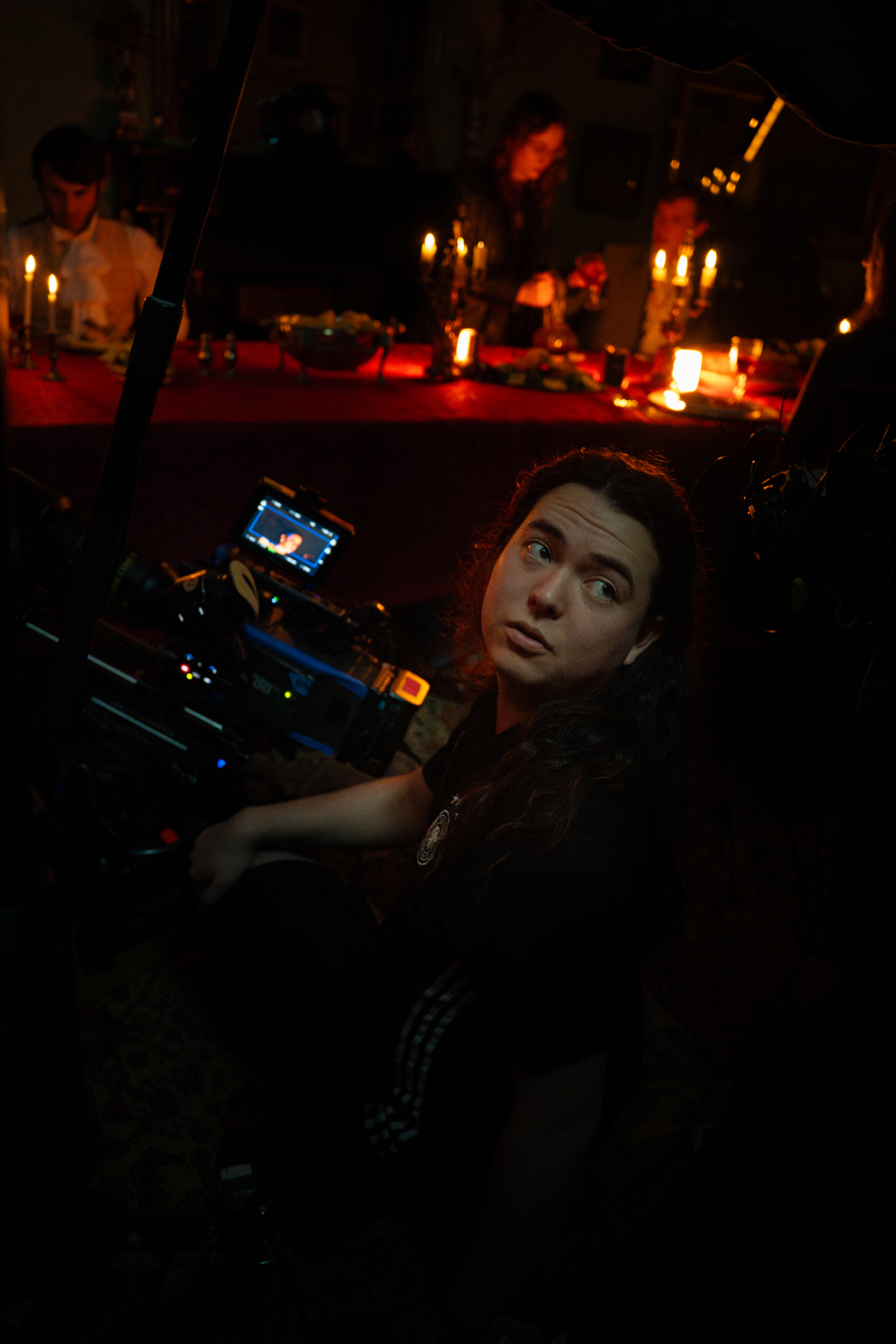 Kai Kobayashi Ryan looks over his shoulder while operating a cinema camera