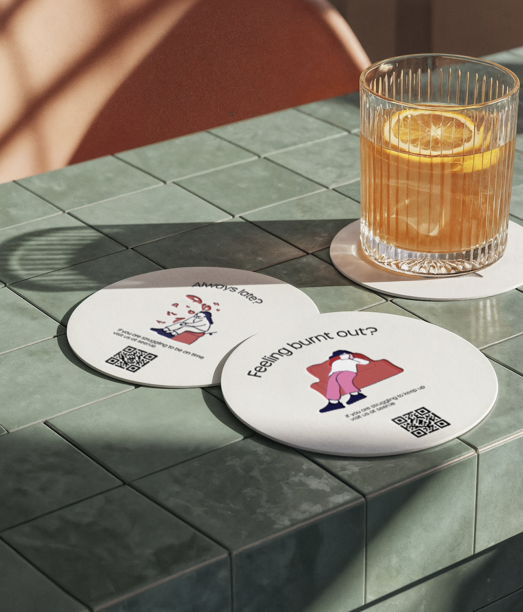 Branded coasters featuring ADHD awareness illustrations and QR codes linking to educational resources and support information.