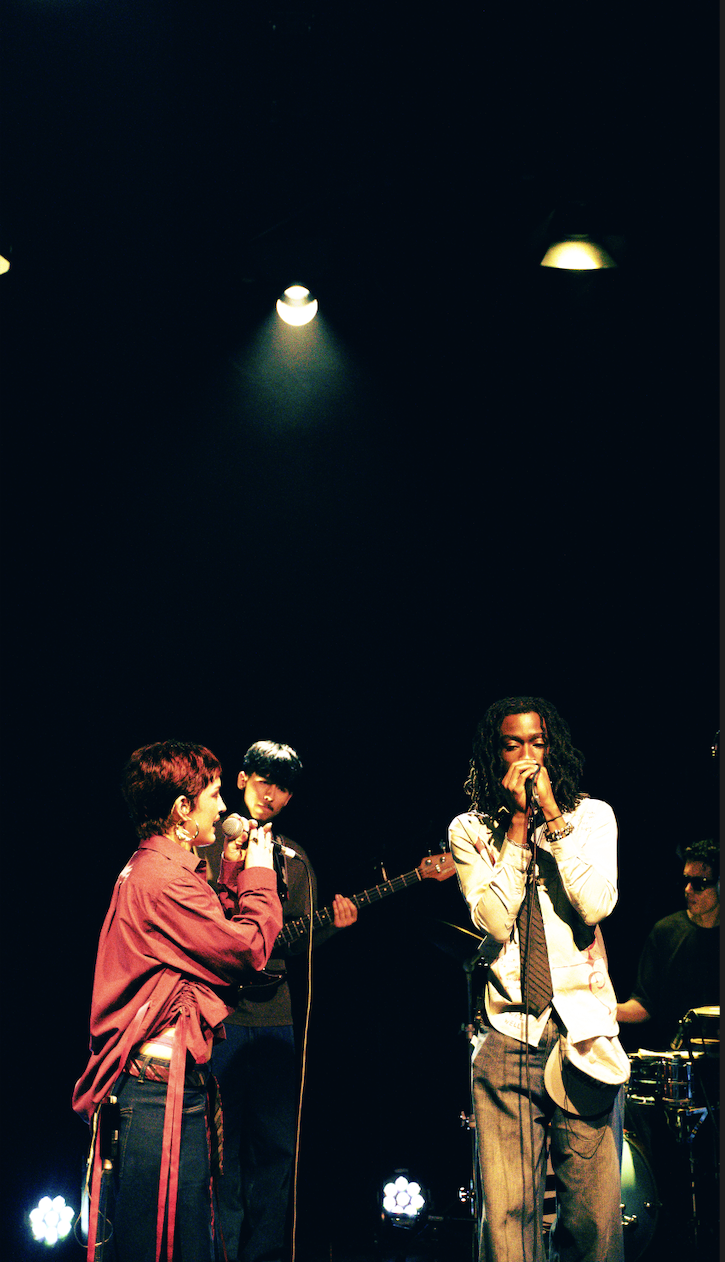 Two artists sing on stage