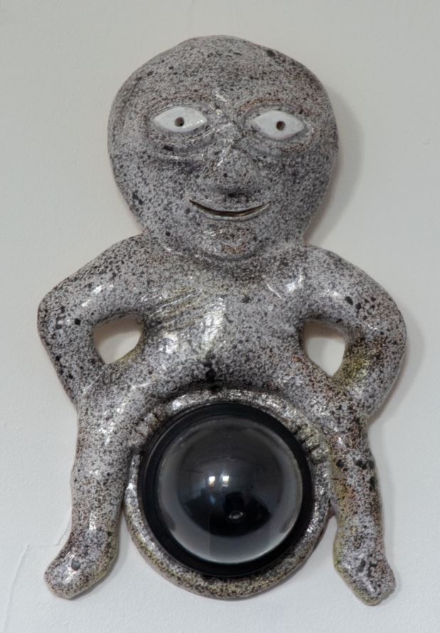 Image of a Sheela-na-gig figure with a dome shaped CCTV camera between her legs.