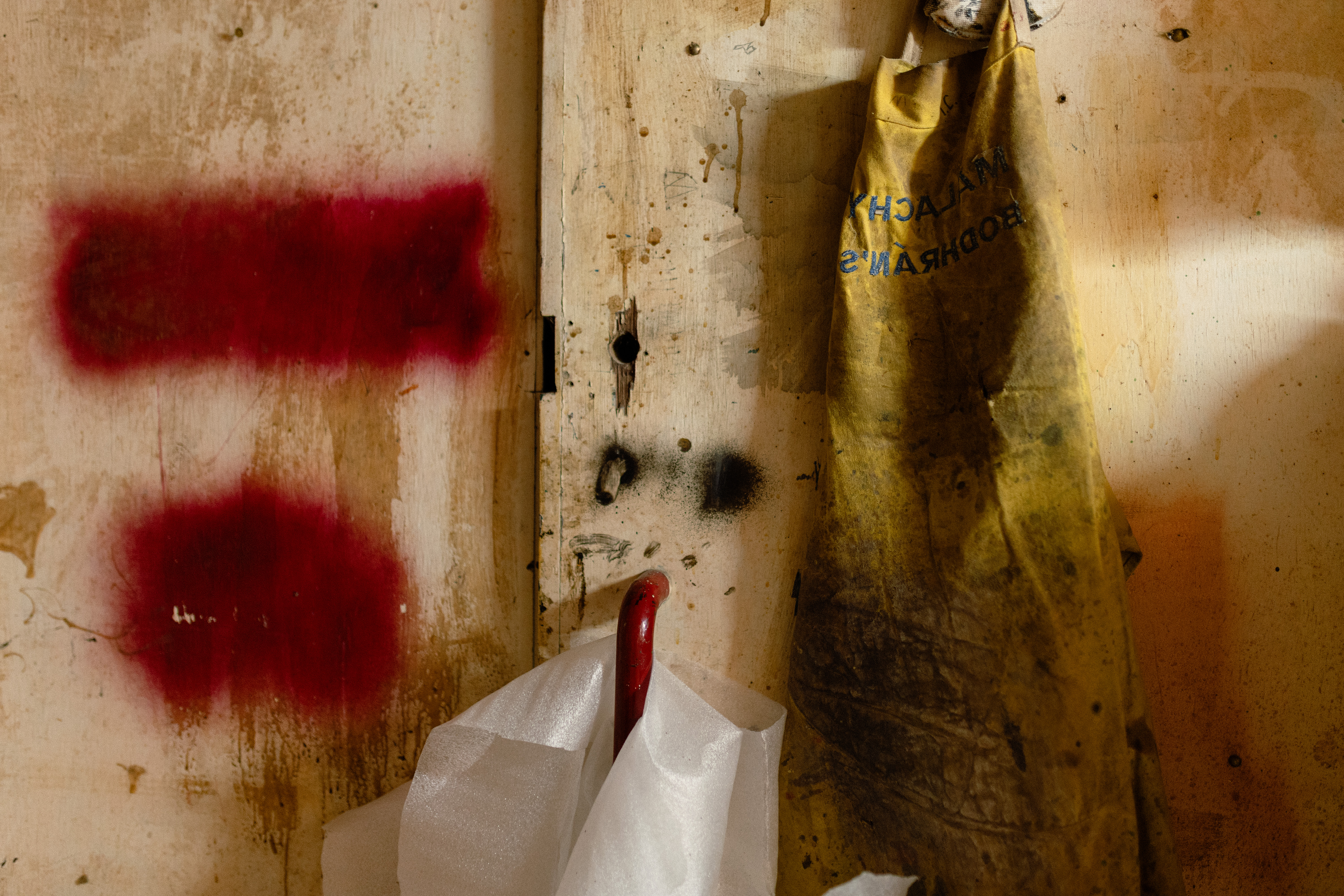 A yellow Apron, hanging on a workshop wall