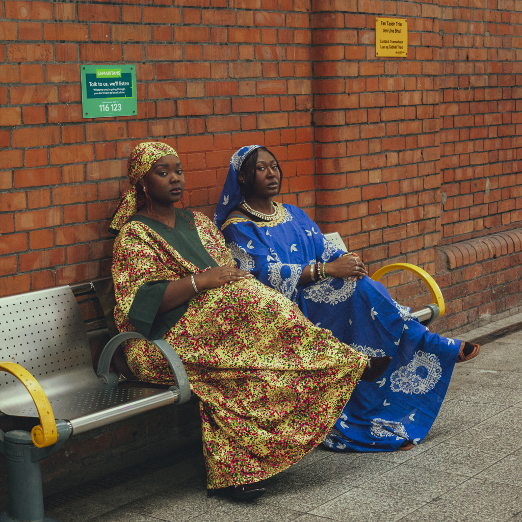 two women sitting in pearse train station