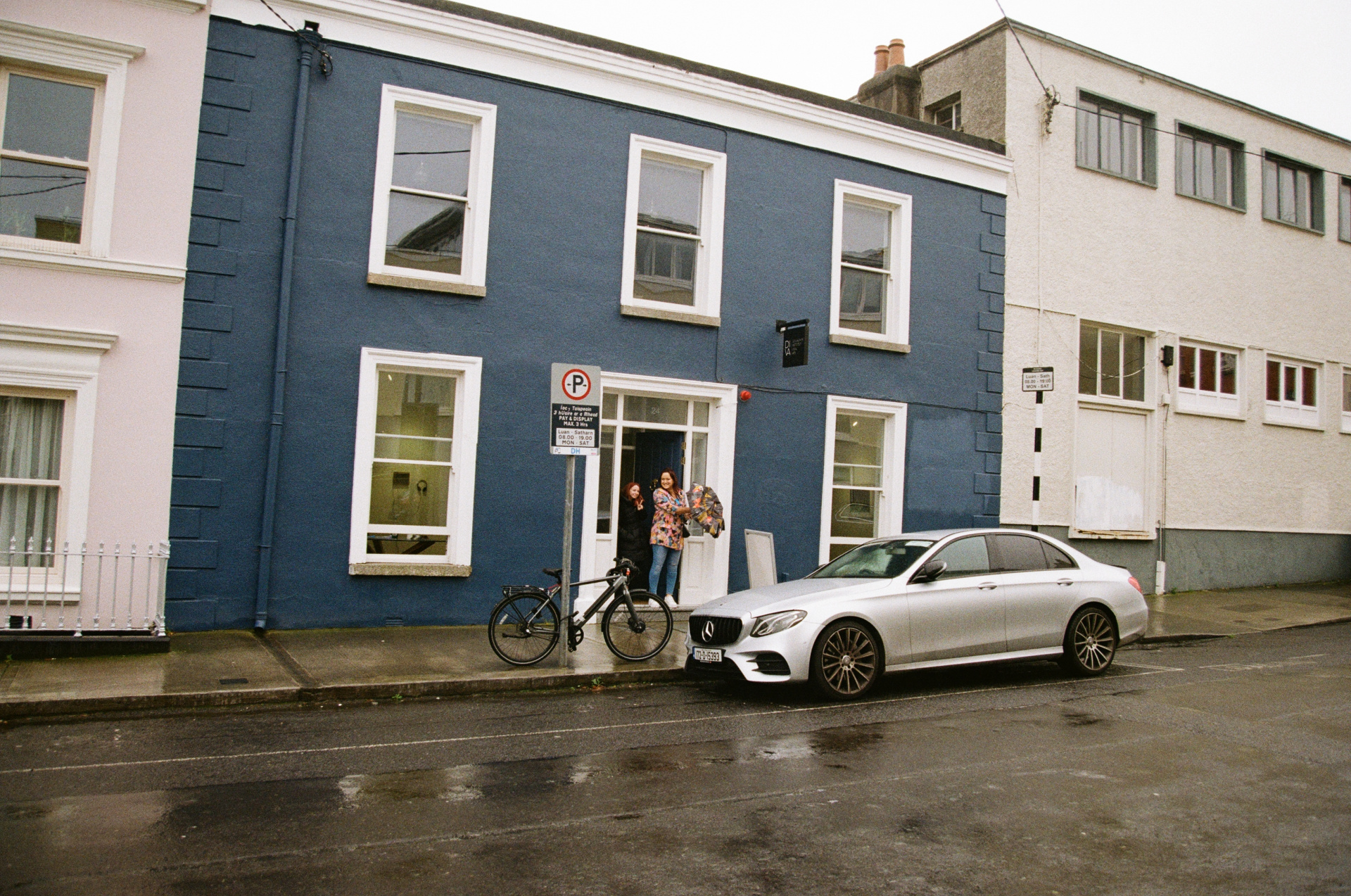 Undertwo photo Car parked outside a building
