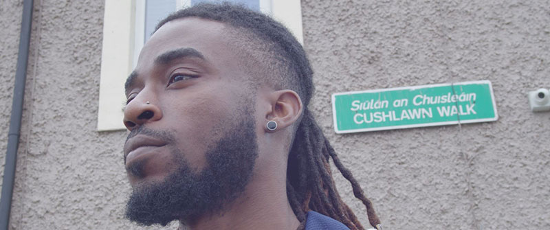 a man in front of a sign that reads 'Cushlawn Walk'