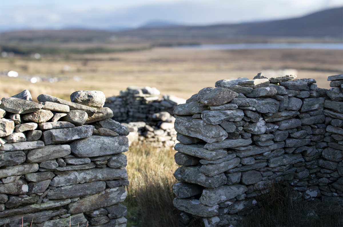 An image taken inside a stone cottage with a detailed view of the build of the old stone doorway