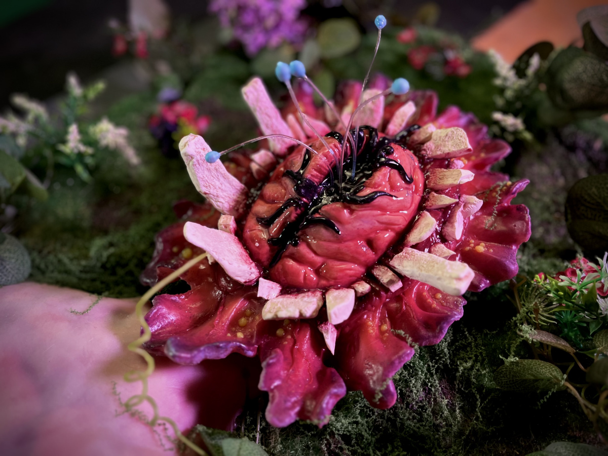 skull ripper lying down in a fake flower bed