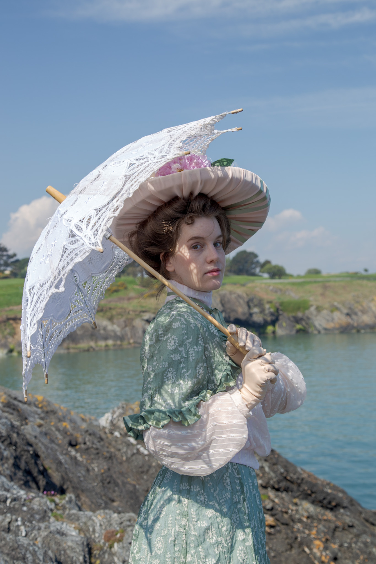 Mary Rose 3/4 looking towards camera holding parasol