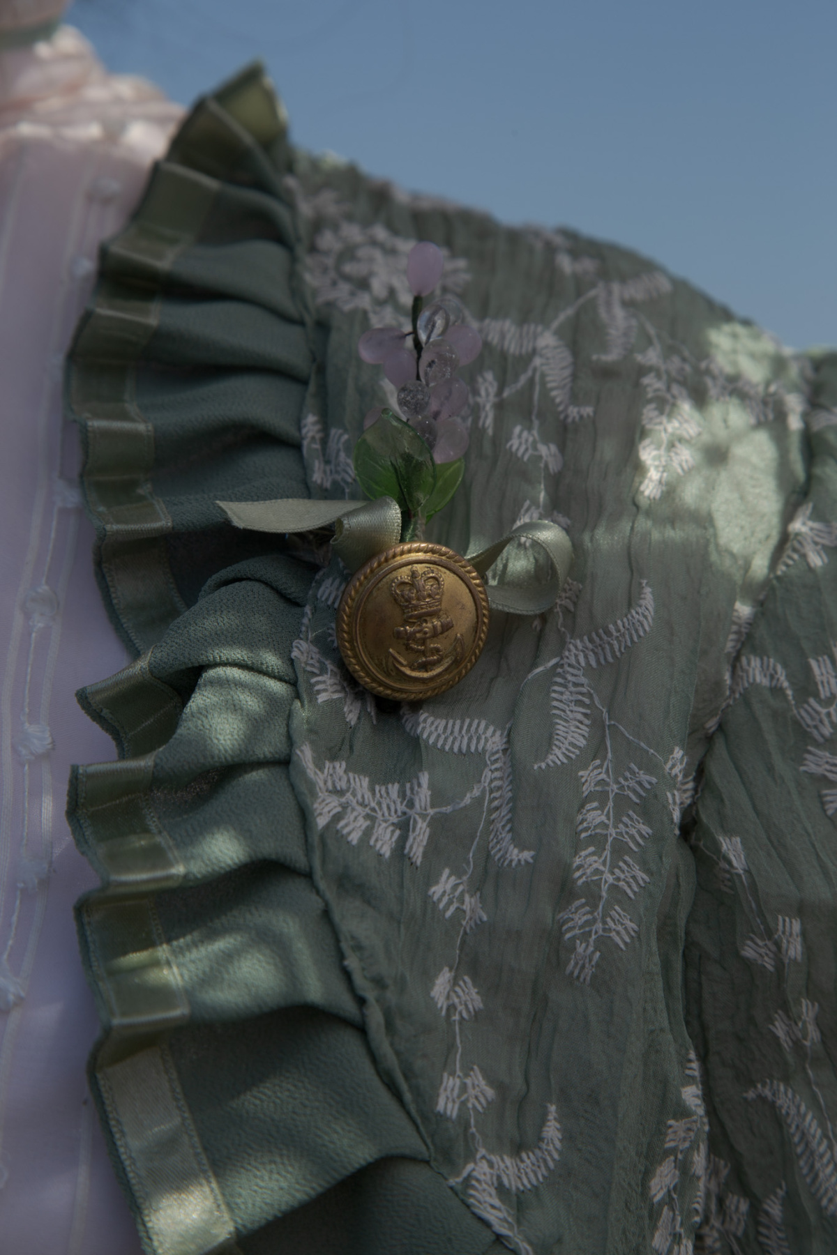 detail of navy button brooch
