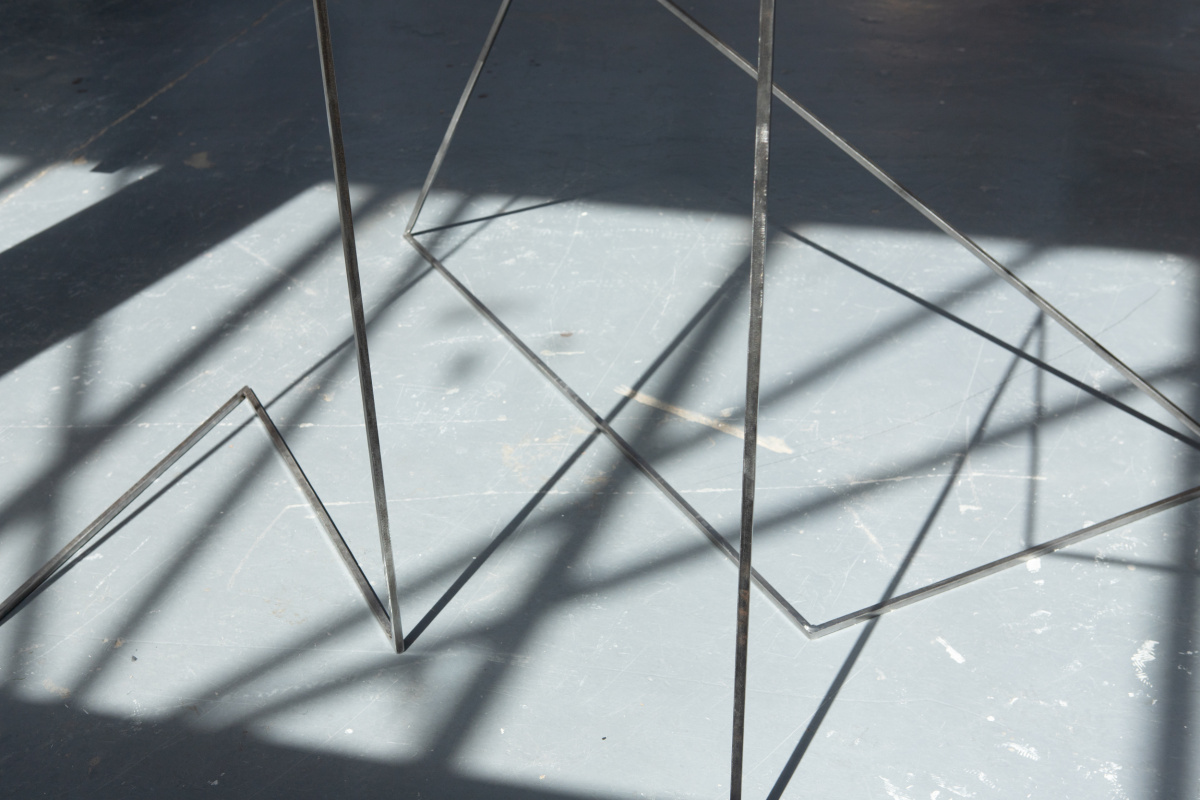 An close up image of steel sculptures and the shadows they cast on the floor