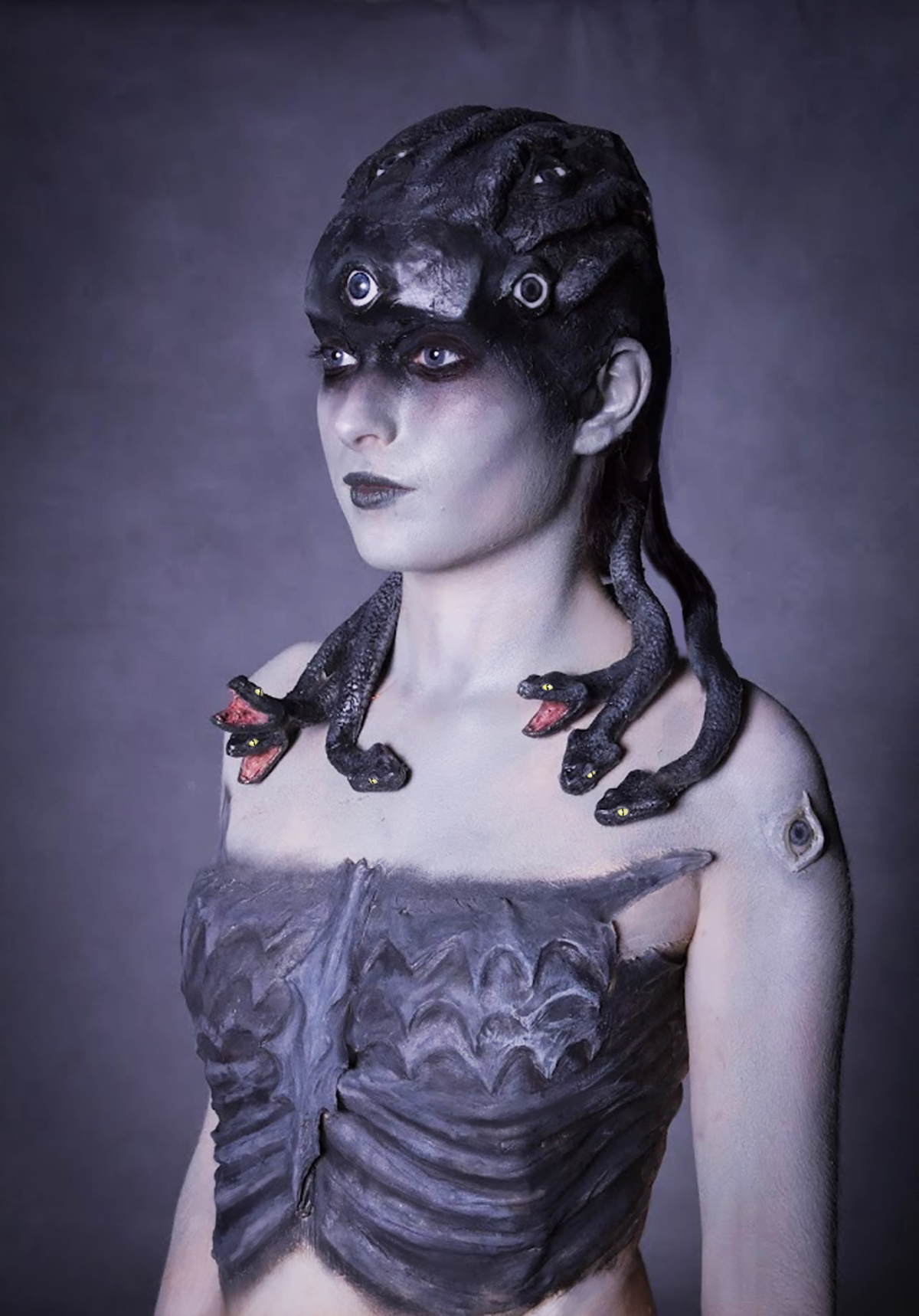 Medusa side shot. Head piece is made out of several parts like bald cap head base, eyes with eyelids, snake skins and snake bodies with two different heads styles.