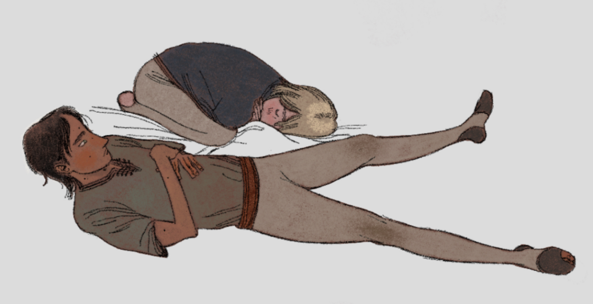 Two young boys sleeping on the floor; one has his eyes open.