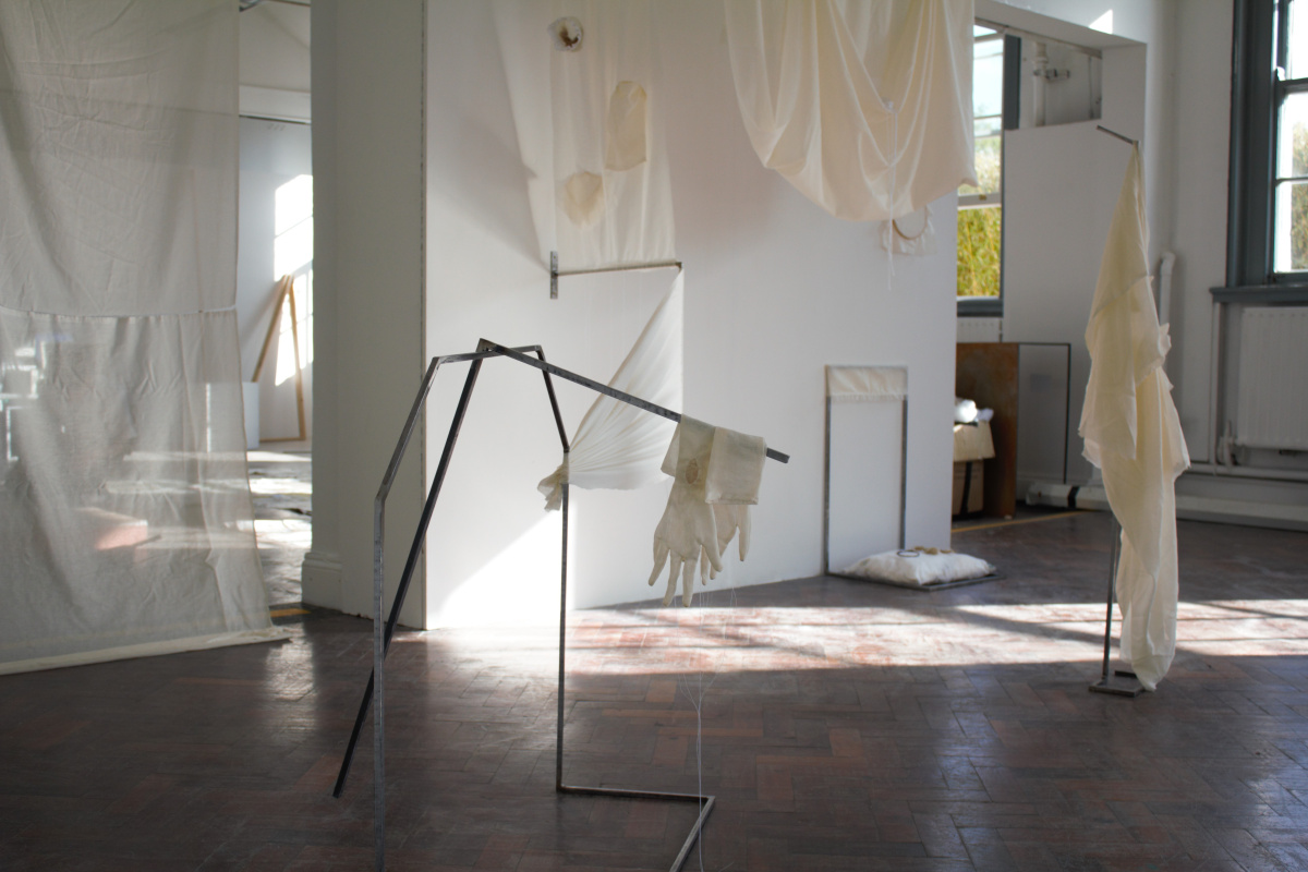 Síofra Ní Bhroin, **Truth to tell, just being here, Housed alone, housed together,** 2025. Cotton muslin, Violin, Yarn, Thread, Hawthorn dye, Mild steel.  