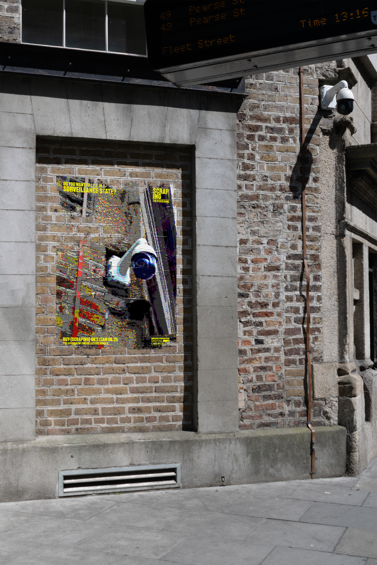 Photograph of promotional poster for video game on brick wall. Poster has pixelated photo of cctv camera, same camera can be seen above it in the street.