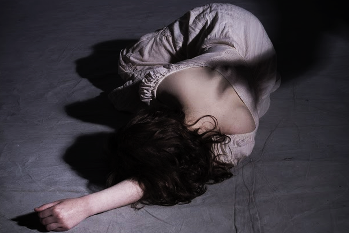 A scary shadow of a man dominantly looming towards the girl to continue his abuse.