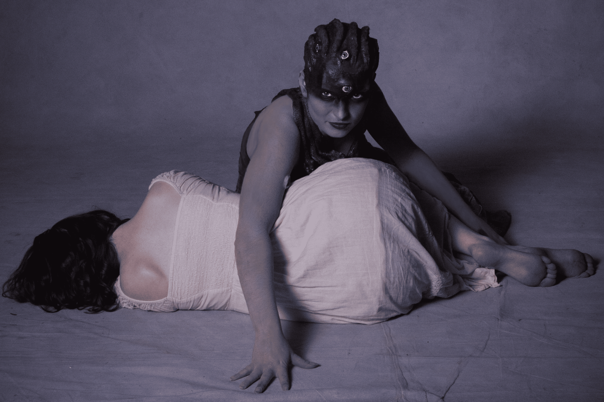 Medusa hides the girl from a man and stands into a fighting pose.