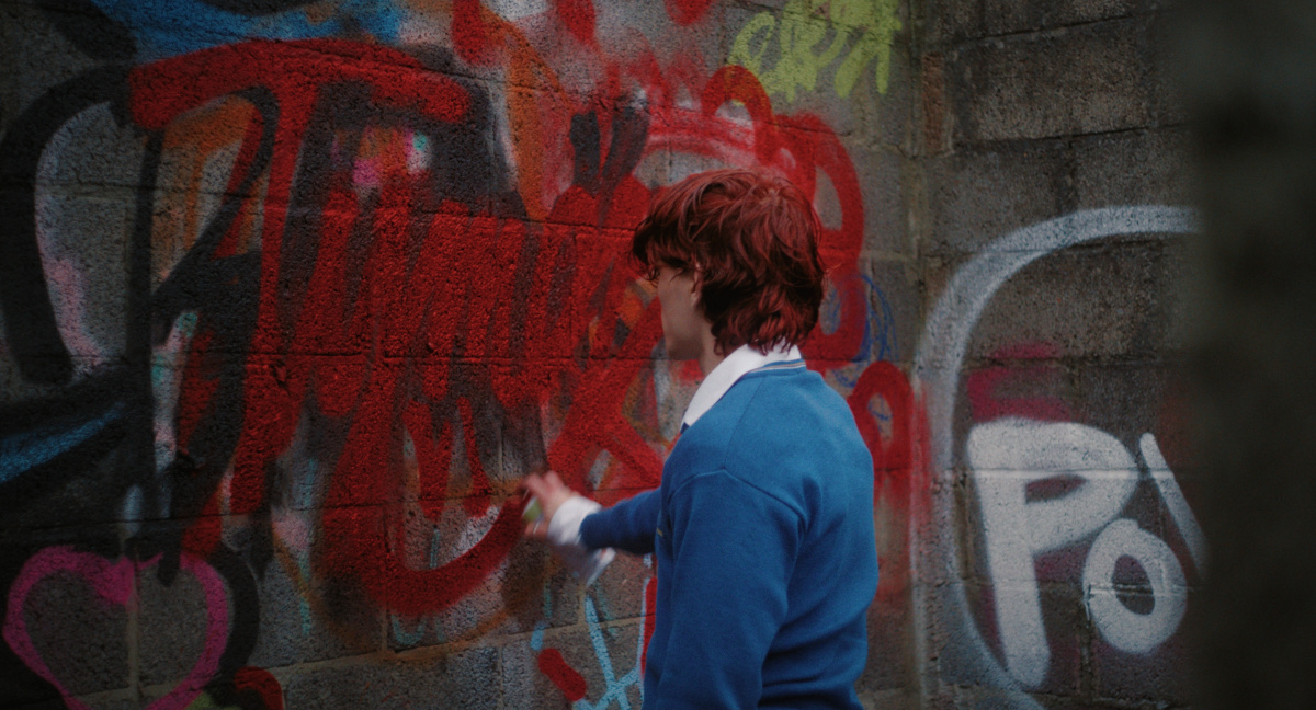 Tymek tagging the wall of the old abandoned building