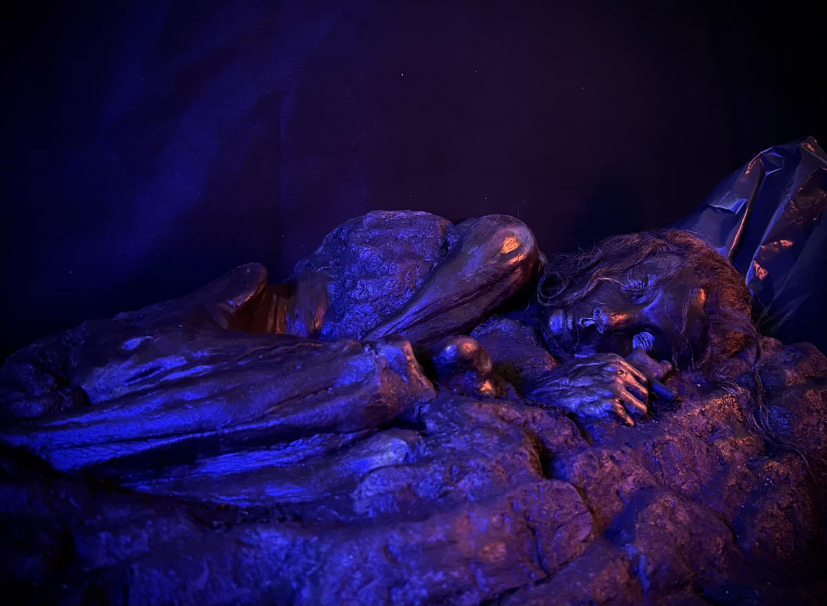 Bog body in sterile blue lighting.