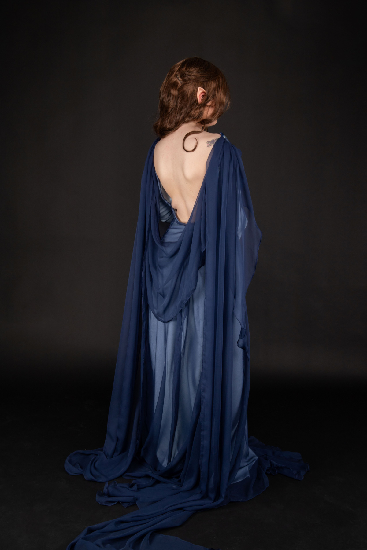 Three-quarter view of the back of the dress, along with the draped back and two trains. Modelled by Ellen Farquhar and photographed by Sarah Lordan.