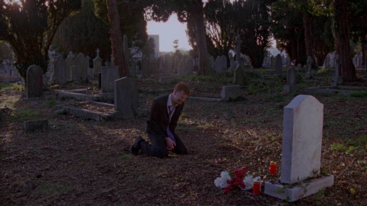 jack kneels and cries in front of a grave