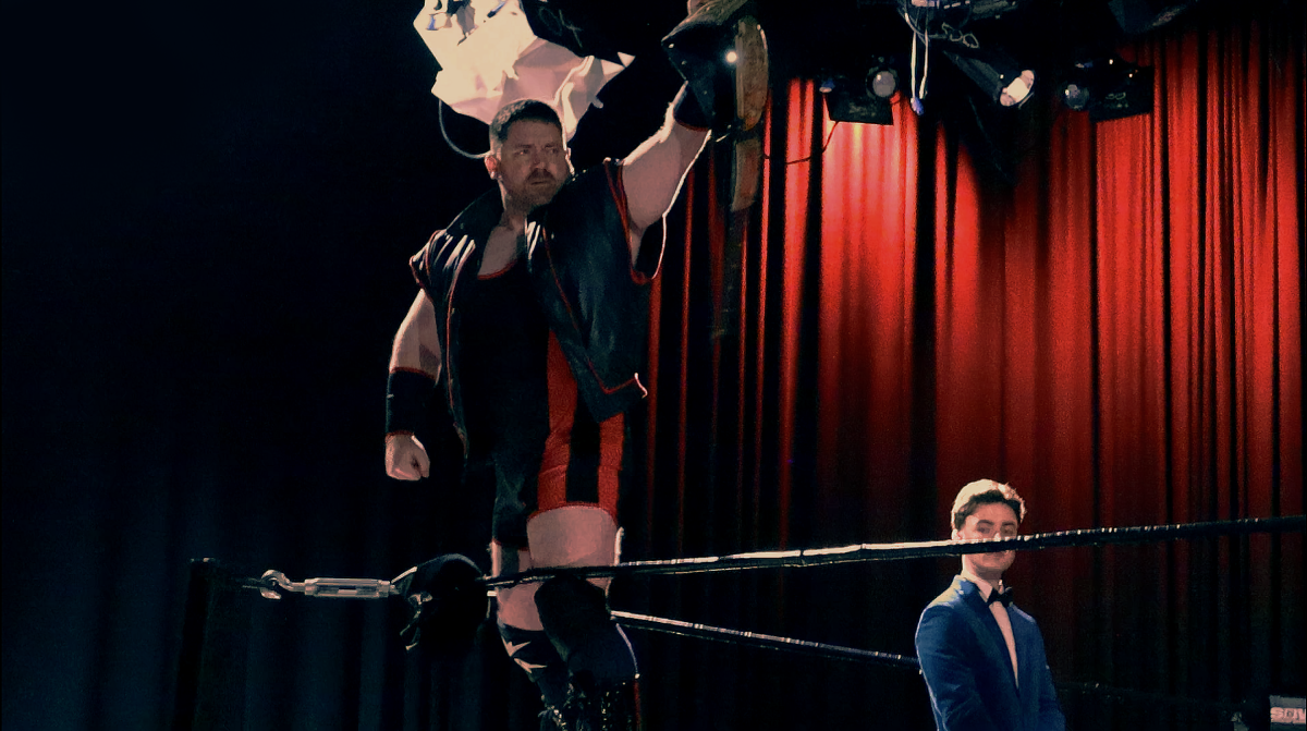Wrestler Holding Belt At The Corner Of The Ring
