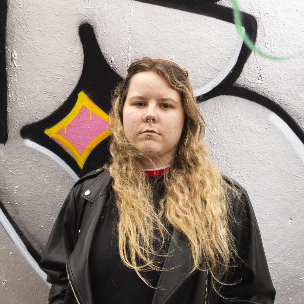 Roisin in front of grafiti wall
